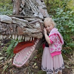 Eva with Tyrannosaurus Rex by Joe Treat at Price Sculpture Forest - photo by Dondi Budde of Oak Harbor